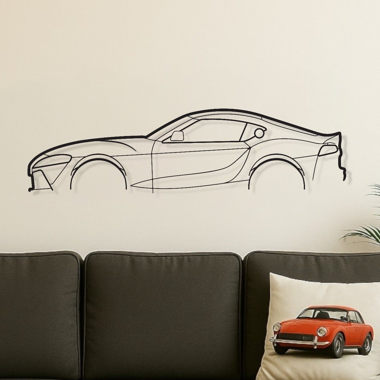 Living room with a gray sofa, wooden coffee table, and car-themed decor.