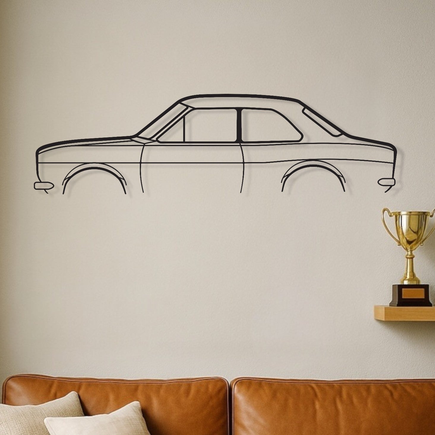 Brown leather sofa with decorative pillows against a wall with a car outline and trophies.