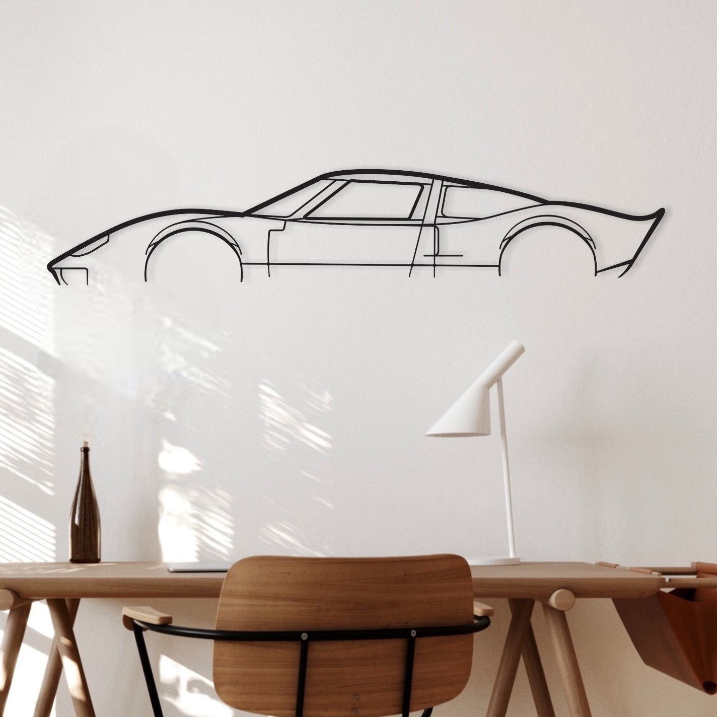 Ford GT40 black metal silhouette hanging in an office.