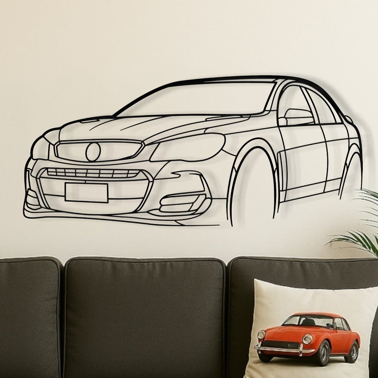 Living room with a gray sofa, coffee table, and decorative pillows featuring car designs.