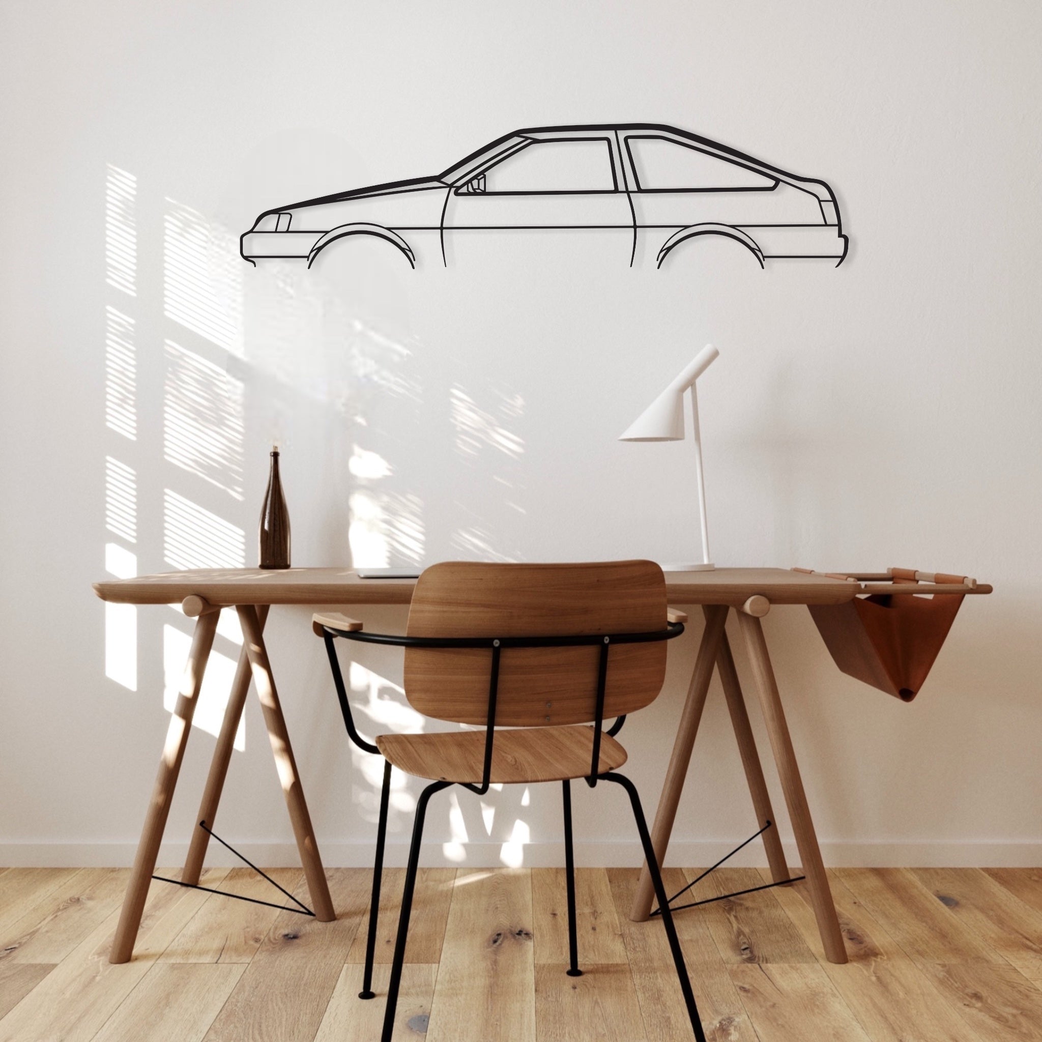 Toyota Corolla Sprinter Levin AE86 car silhouette wall art hangs in an office.