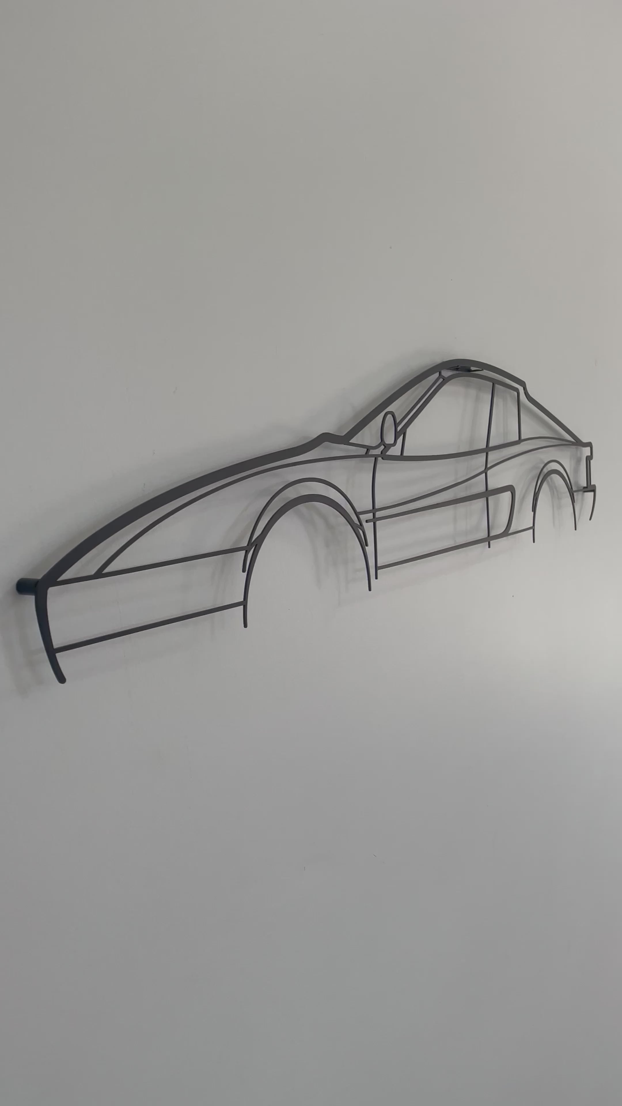Ferrari Testerossa auto art side-on against a white wall.