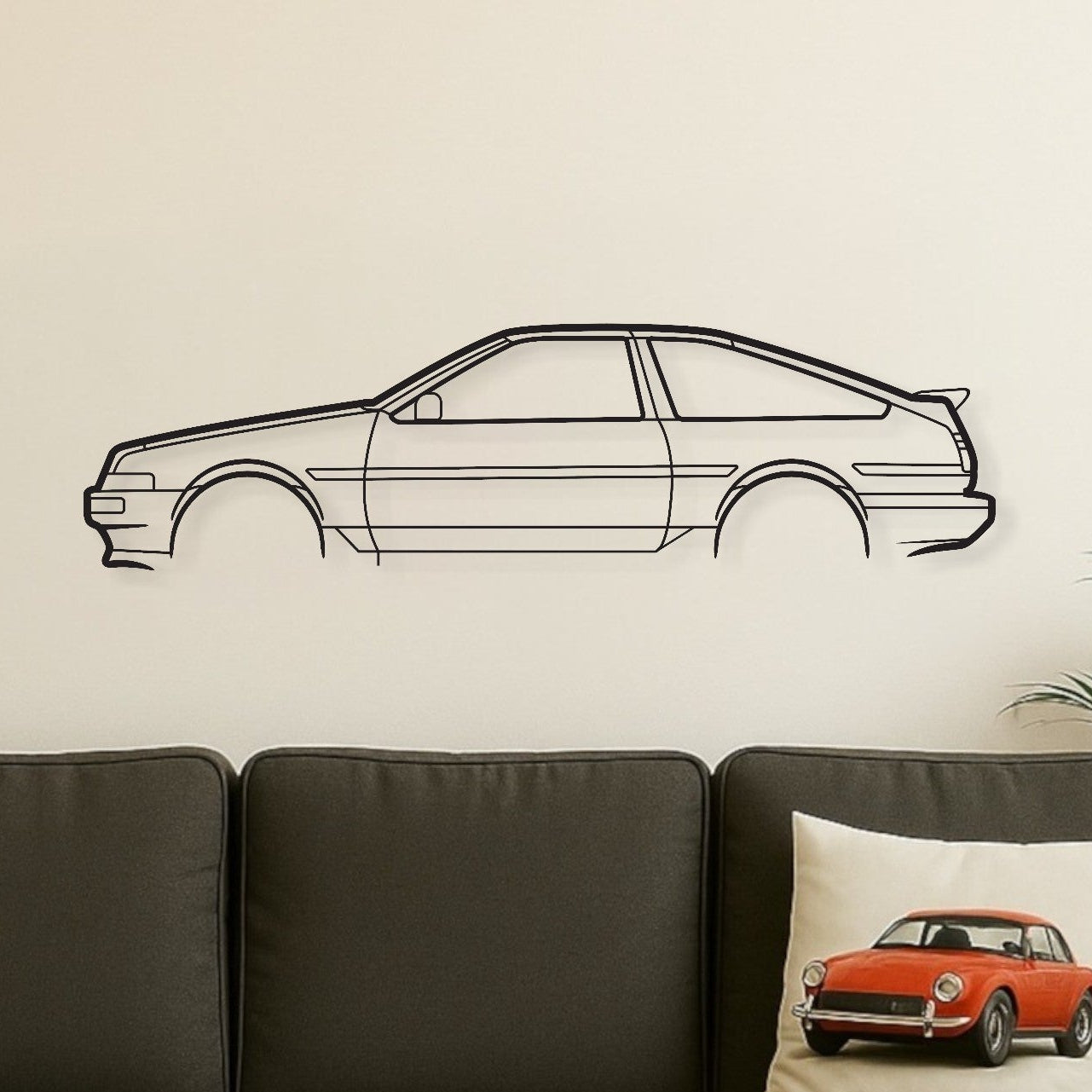 Living room with a gray sofa, wooden coffee table, and car-themed decor.
