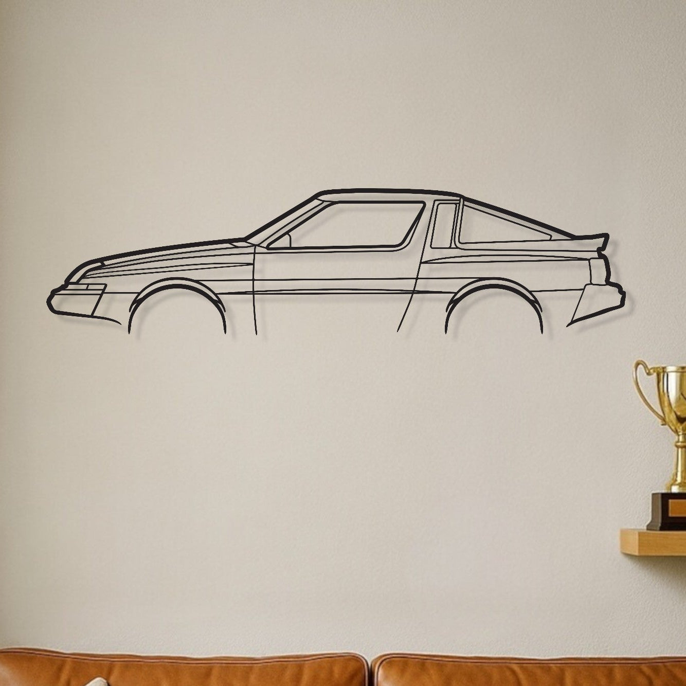 Brown leather sofa with decorative pillows in a room with a car wall decal and trophies on a shelf.