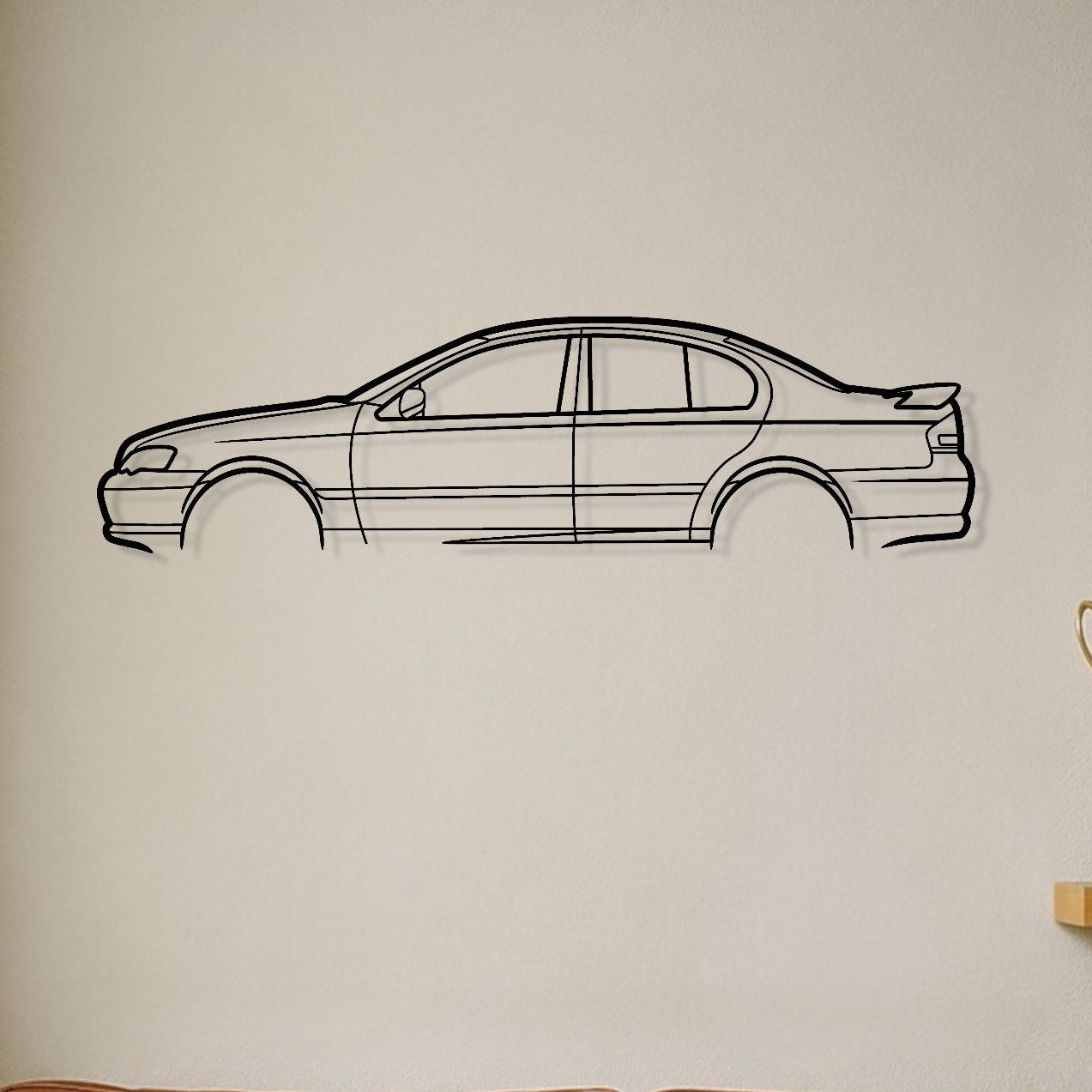 Brown leather sofa with decorative pillows, car wall decal, and trophies on a shelf.