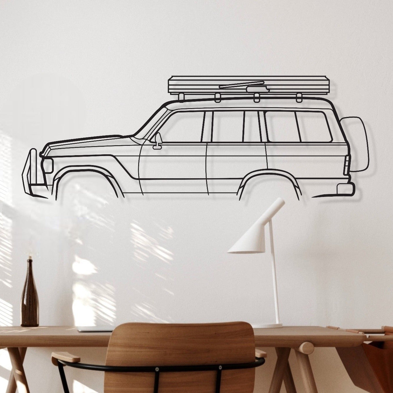 Wooden desk with chair in a room with a whiteboard and car outline on the wall.