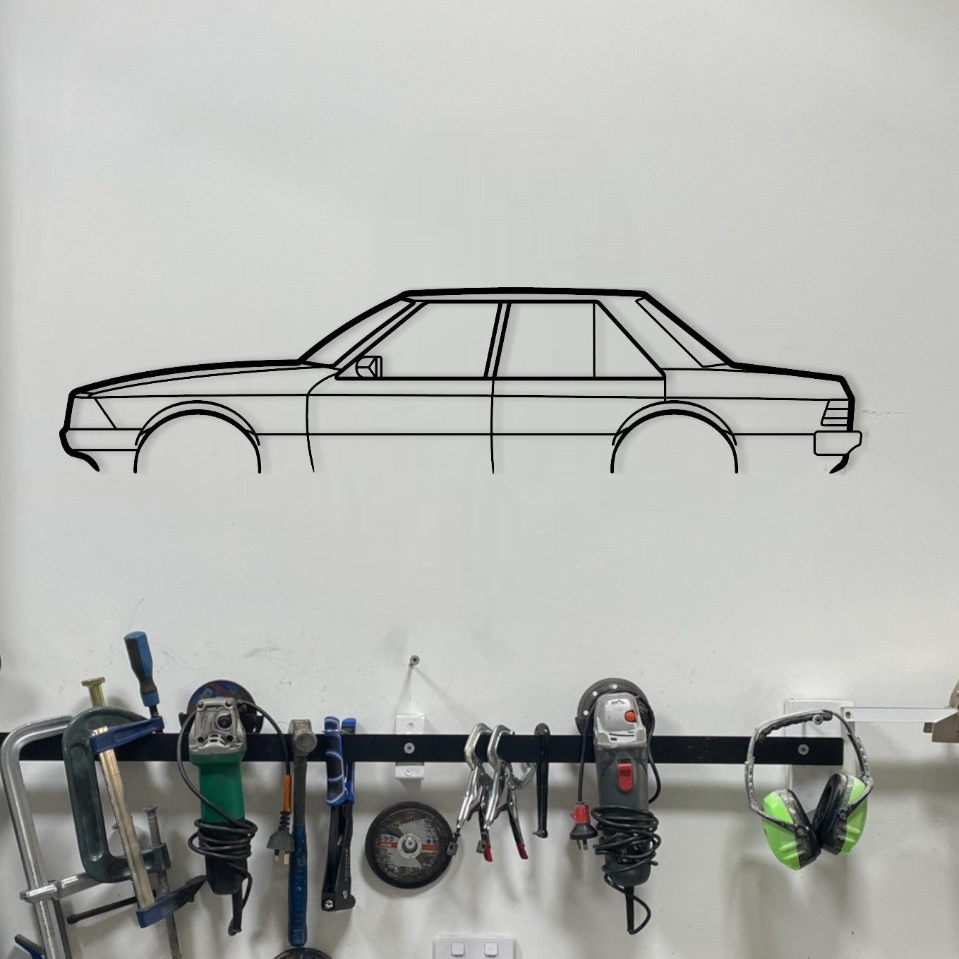 Garage wall with tool rack and car decal