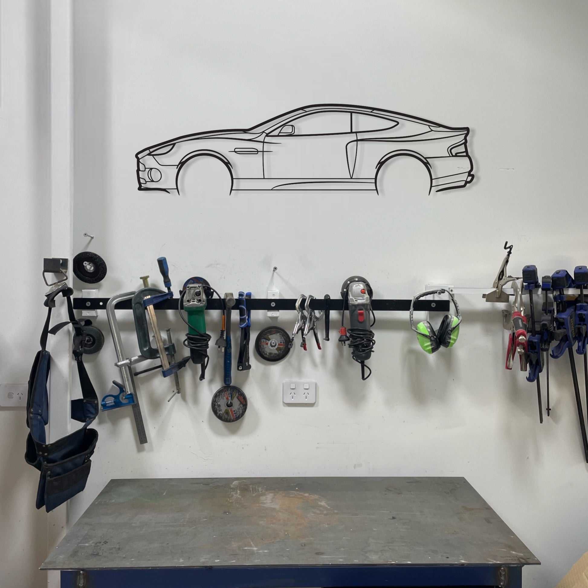 Aston Martin Vanquish metal wall art on workshop, garage wall