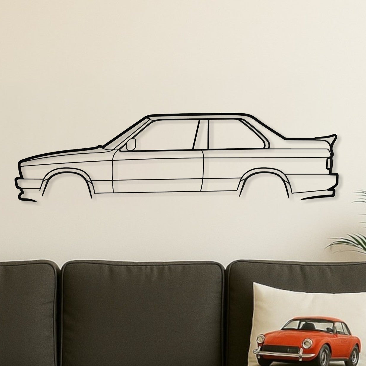 Living room with a gray sofa, wooden coffee table, and wall decal of a car.