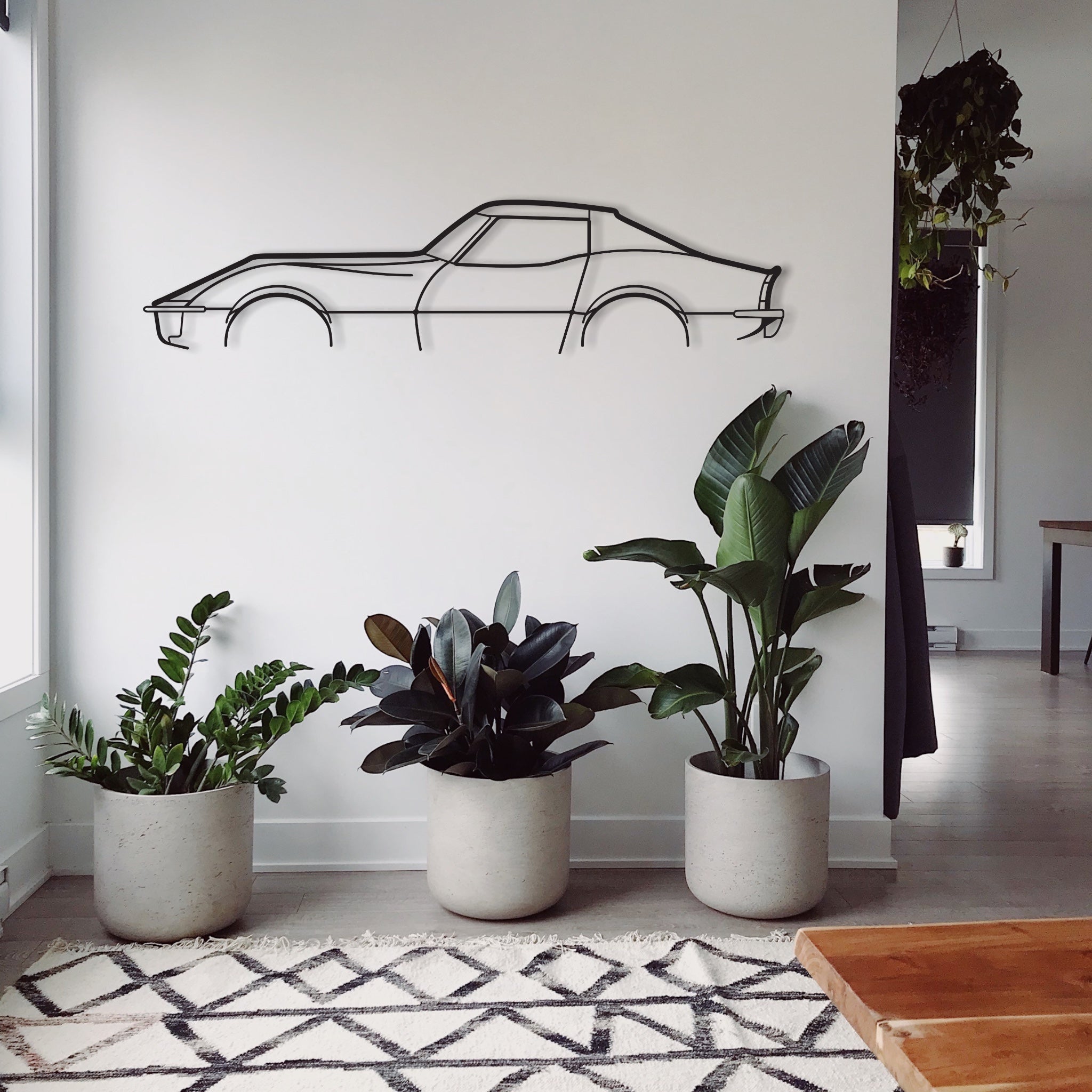 Chevrolet Corvette C3 Stingray car wall hanging featured in a loungeroom with plants.