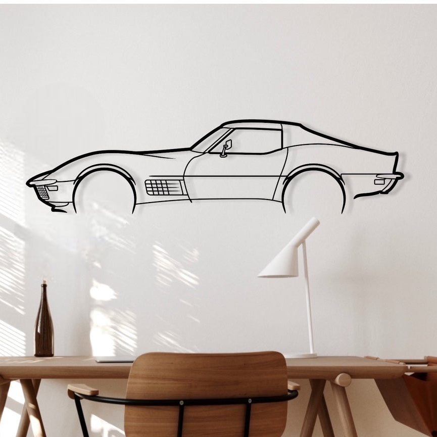 A wall-mounted silhouette of a Chevrolet Corvette C3 Stingray in a home setting, above a desk and chair.