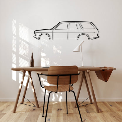 Wooden desk with chair against a white wall with a car outline.