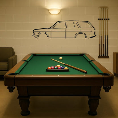 Pool table with billiard balls and cues in a room with a wall decal of a car.