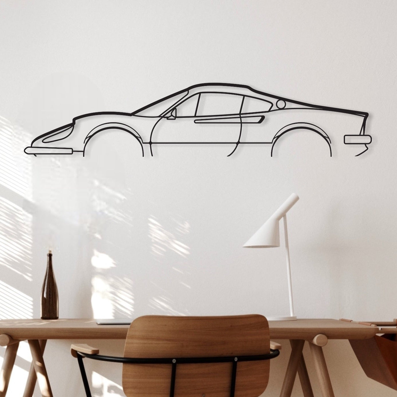 The Ferrari Dino 246 GT car decor hanging above an office desk. 