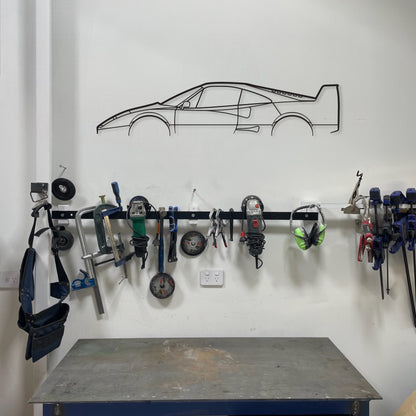 The Ferrari F40 hanging in a garage with tools