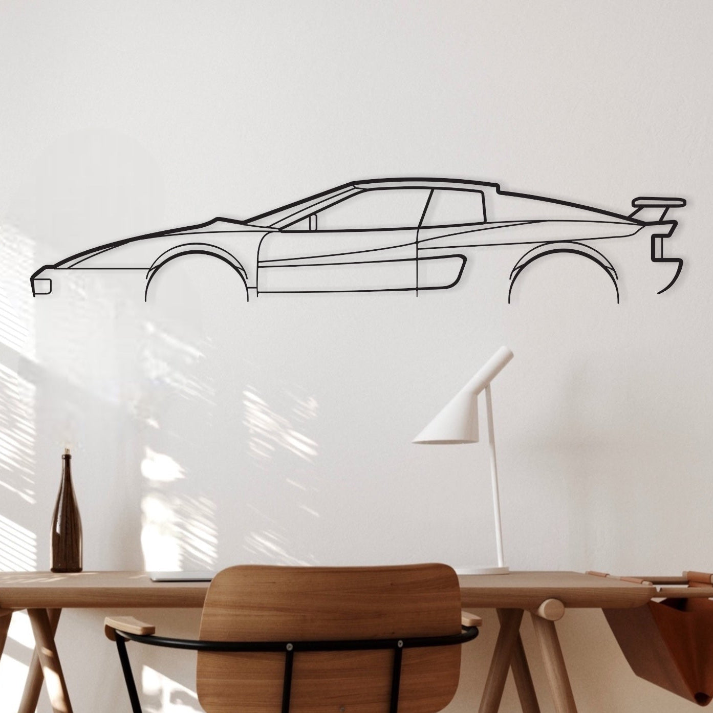 The Ferrari Testarossa Koenig silhouette wall art hanging in an office. 