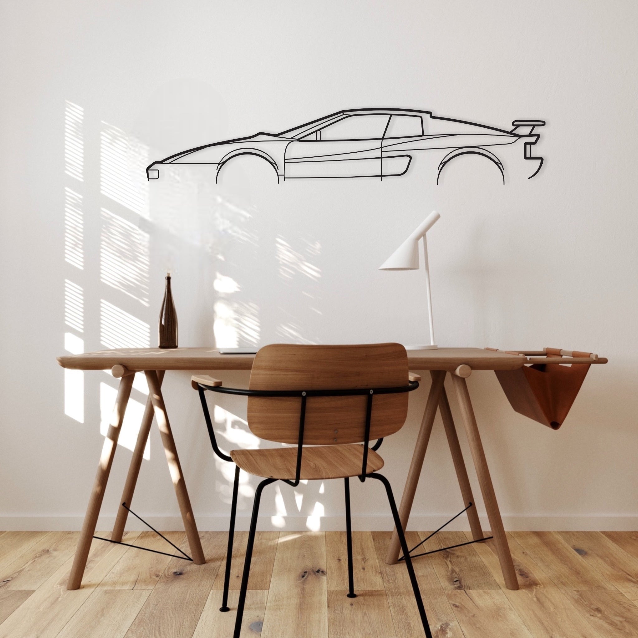 The Ferrari Testarossa Koenig silhouette wall art hanging in an office. 