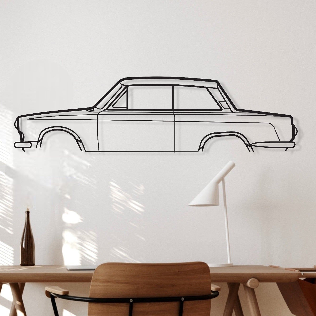 Wooden desk with chair in a room with a car outline on the wall