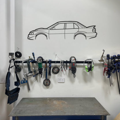 Garage wall with tool rack and car outline on a white wall