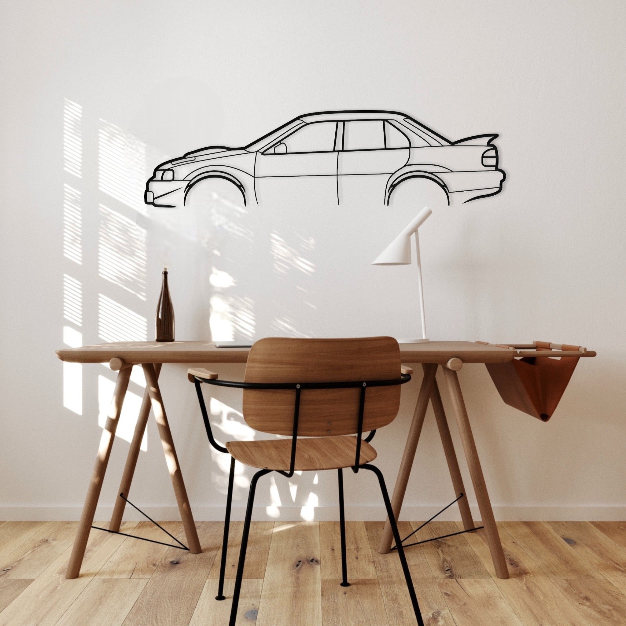 Wooden desk with chair against a wall with a car outline.