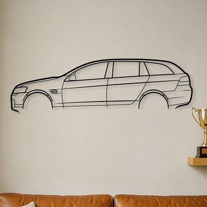 Brown leather sofa with decorative pillows, car wall decal, and trophies on a shelf.
