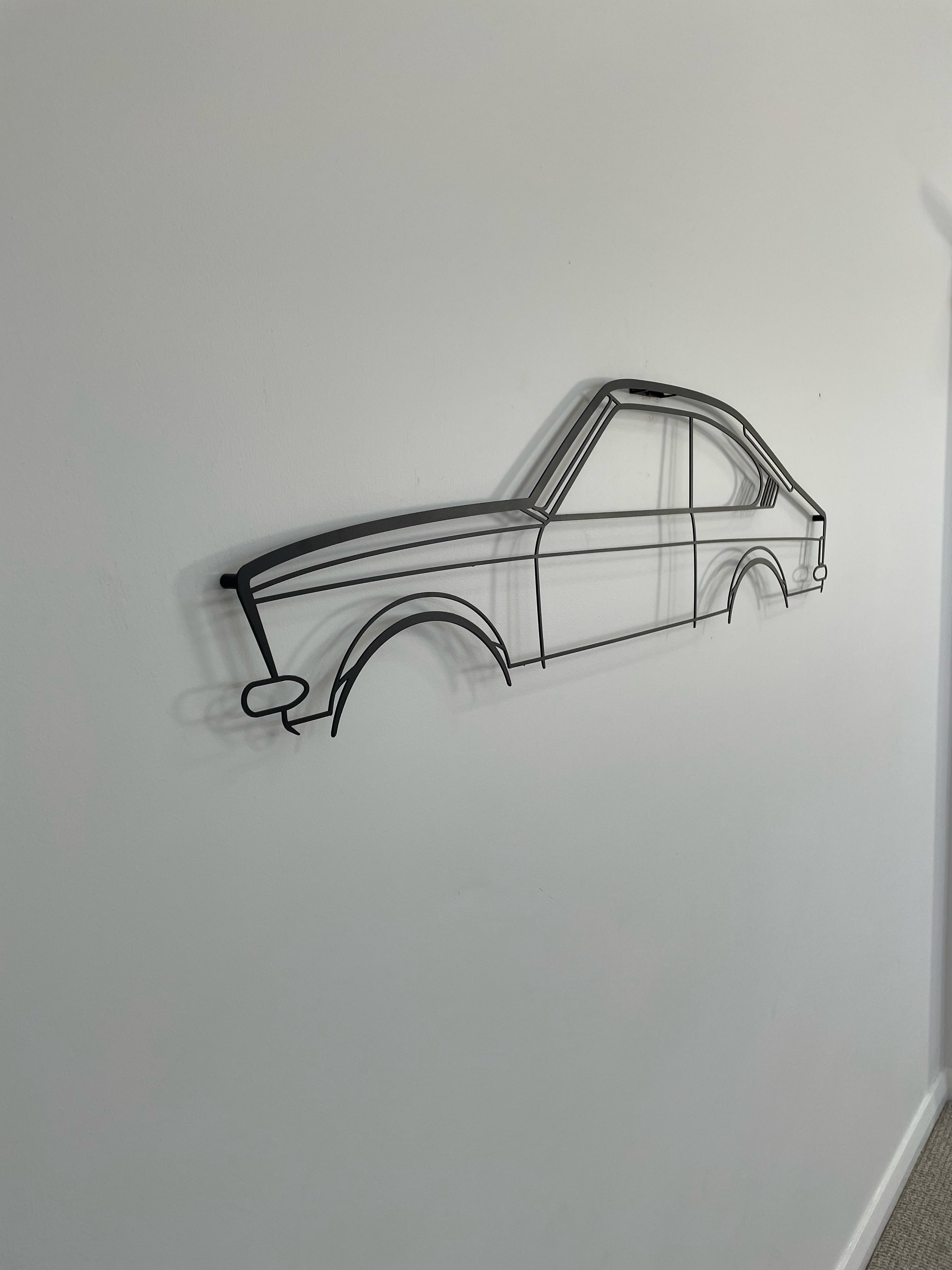 Holden Gemini Opel wall hanging side-on against a white wall. 