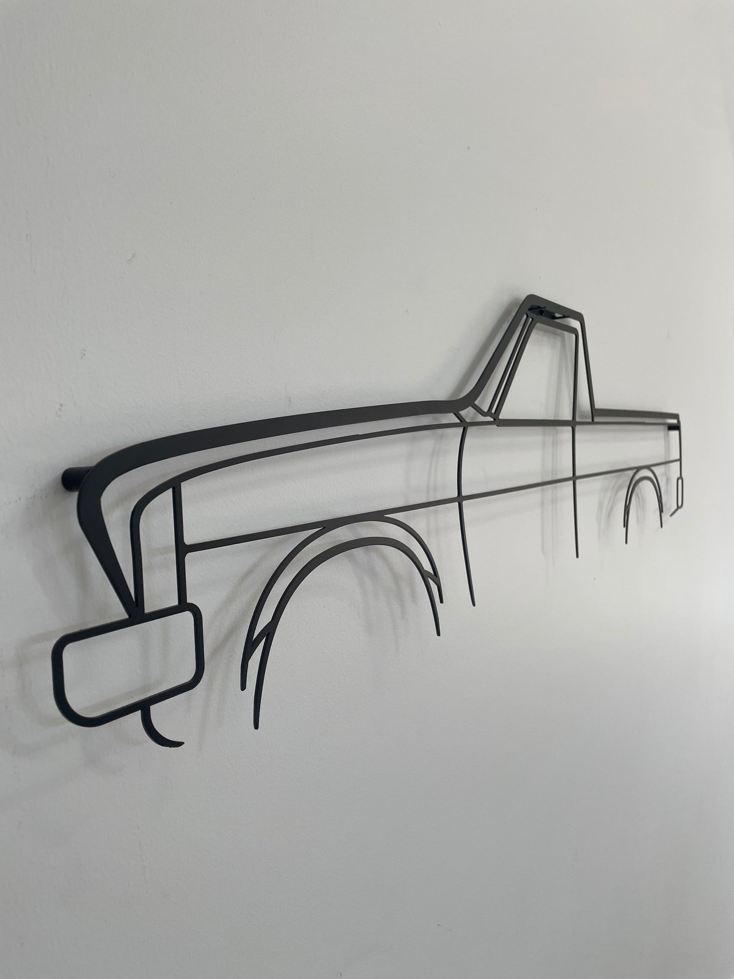 Holden HX Ute silhouette artpiece side-on, hung on a white wall.