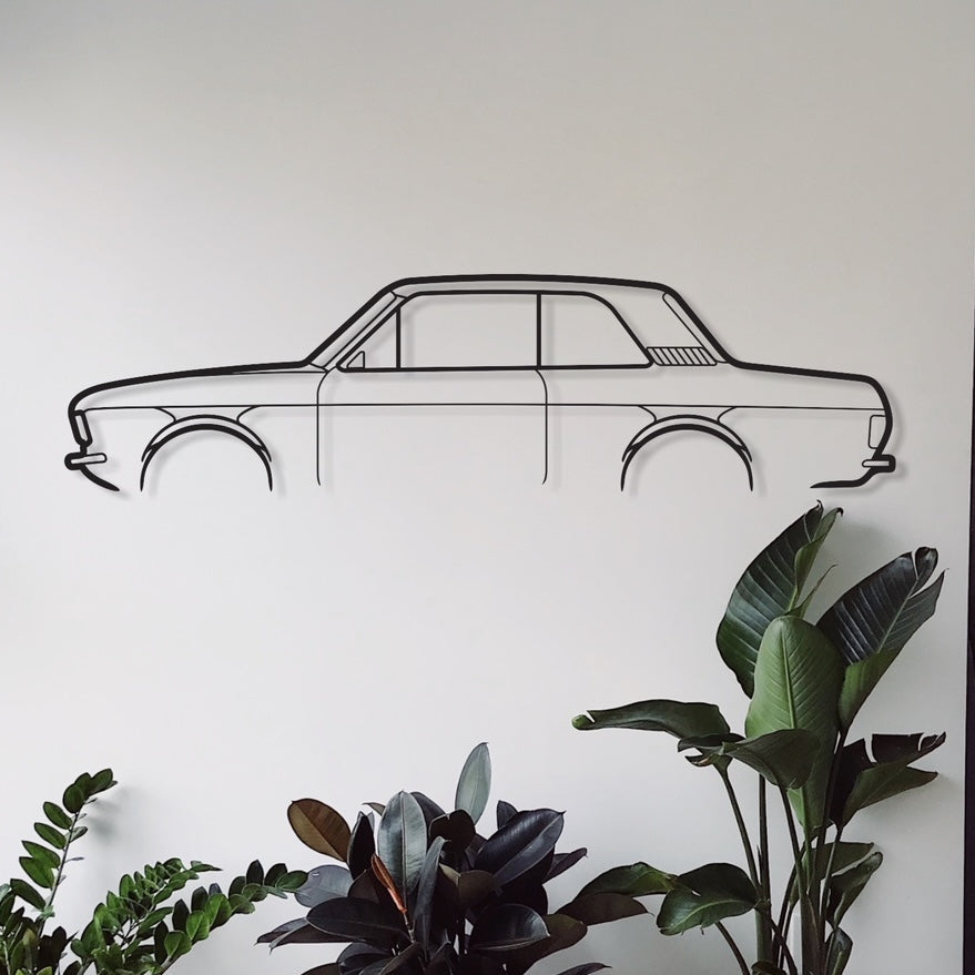 A wall-mounted metal silhouette of a Ford Cortina MK2 2Door car in a room with indoor plants and a geometric patterned rug.
