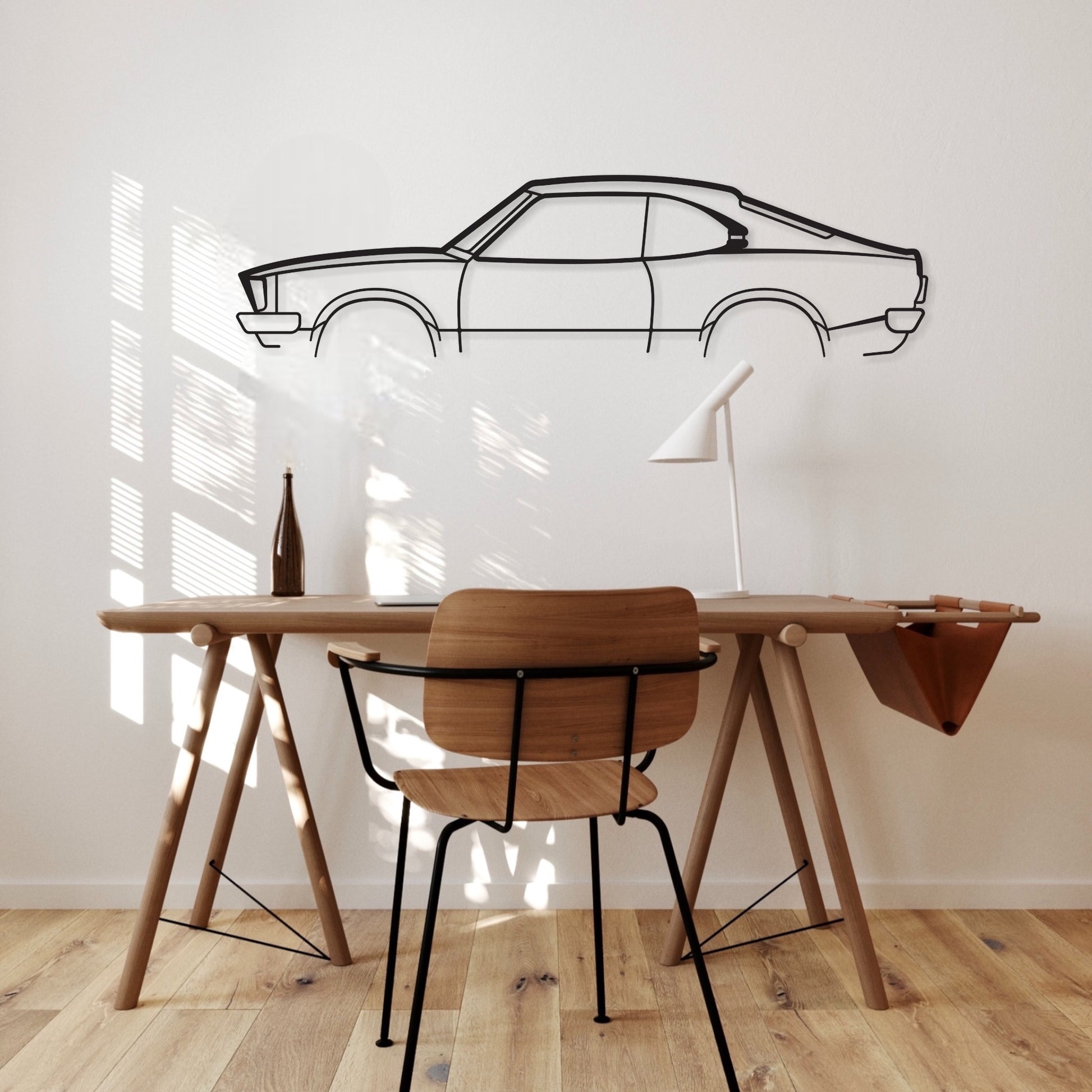 Mazda RX3 2 Door car silhouette wall art hangs in an office. 