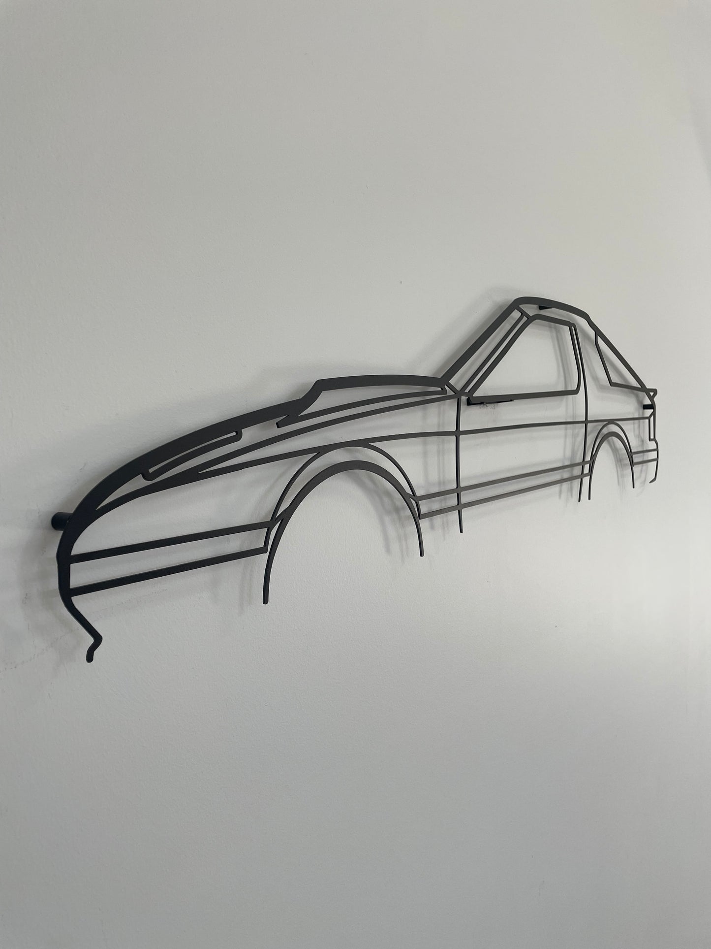 Mazda RX7 Series 4 auto metal art side-on against a white wall. 