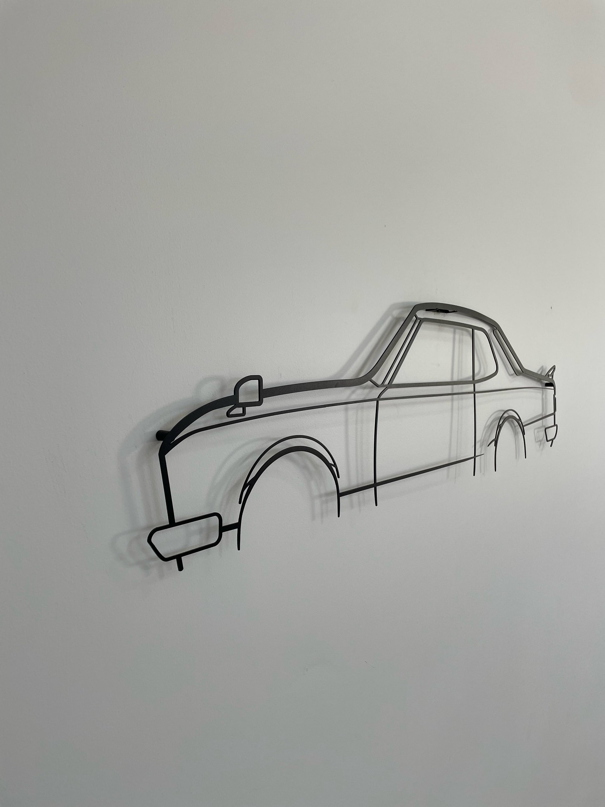 Nissan Skyline C10 GTR 2-Door side-on, hung on a white wall.