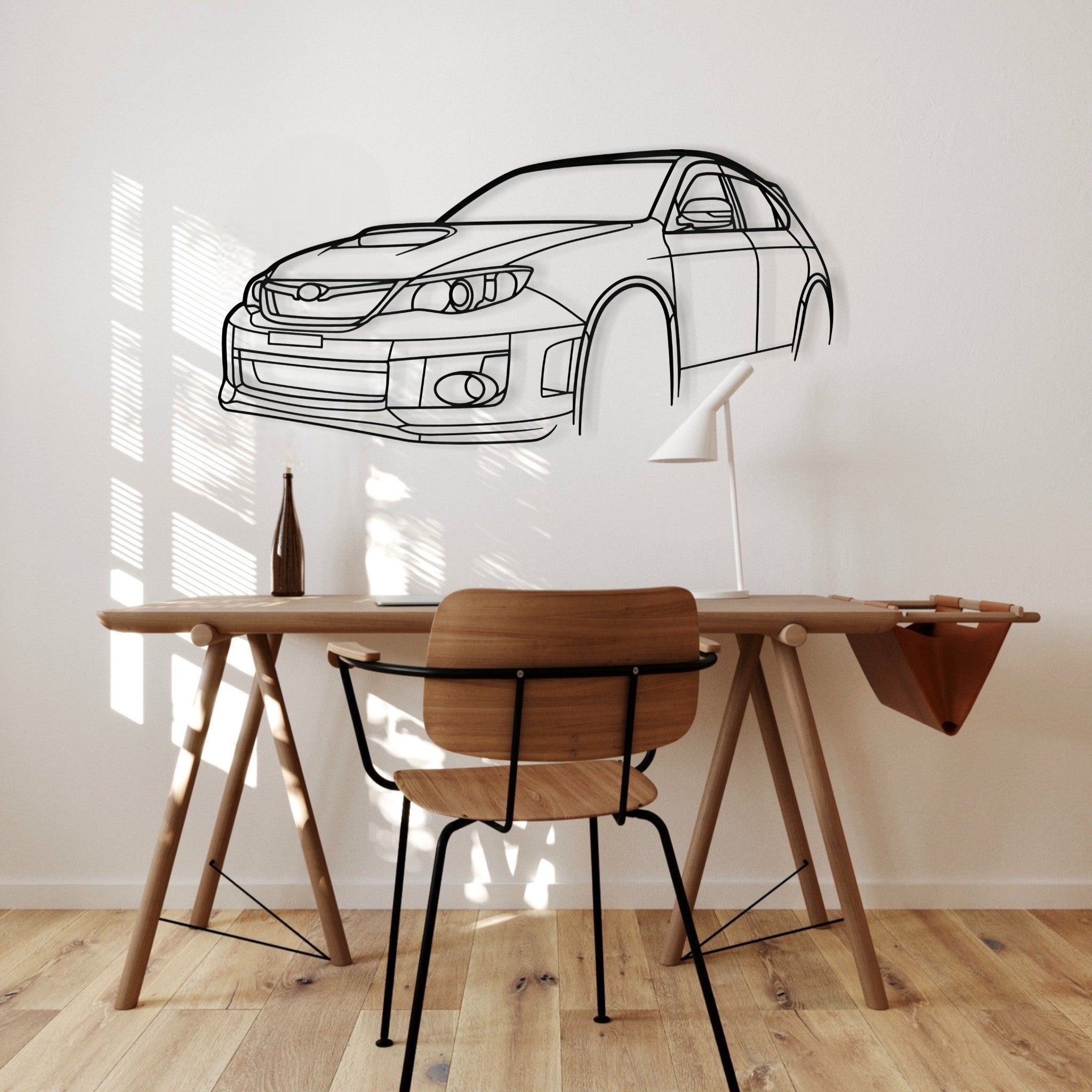 Subaru Impreza WRX STi Hatchback steel silhouette wall art displayed in a study on a white wall with a desk
