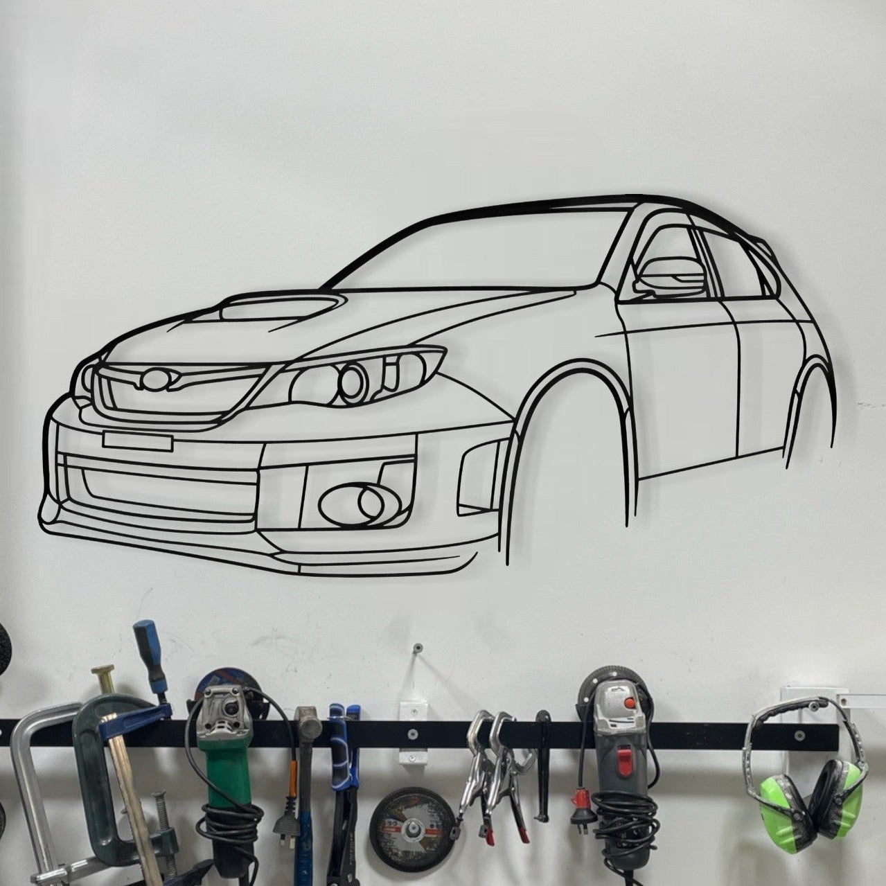 Subaru Impreza WRX STi Hatchback steel silhouette wall art displayed in a modern garage or man cave