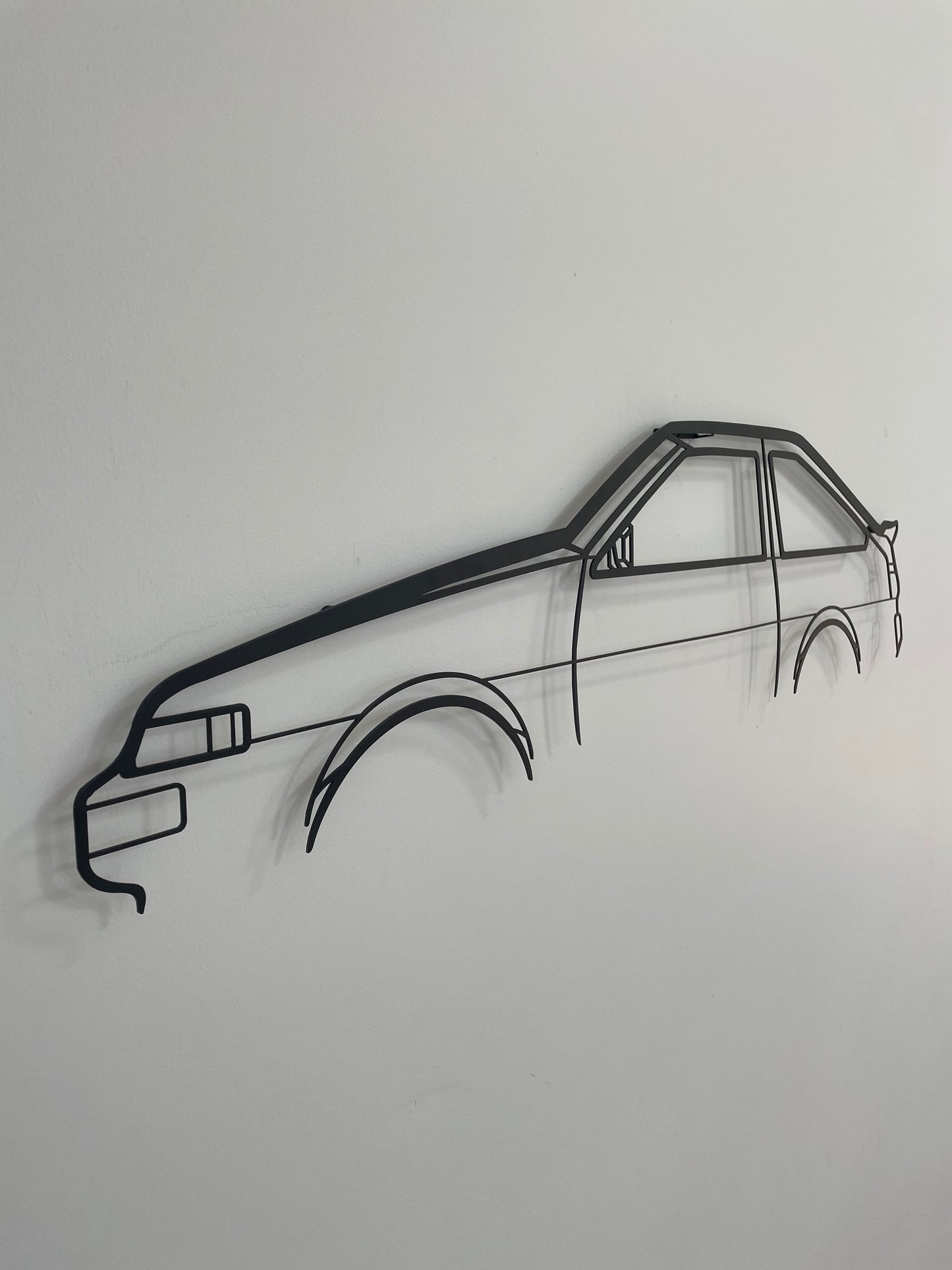 Toyota 86 Tureno side-on, hung on a white wall.