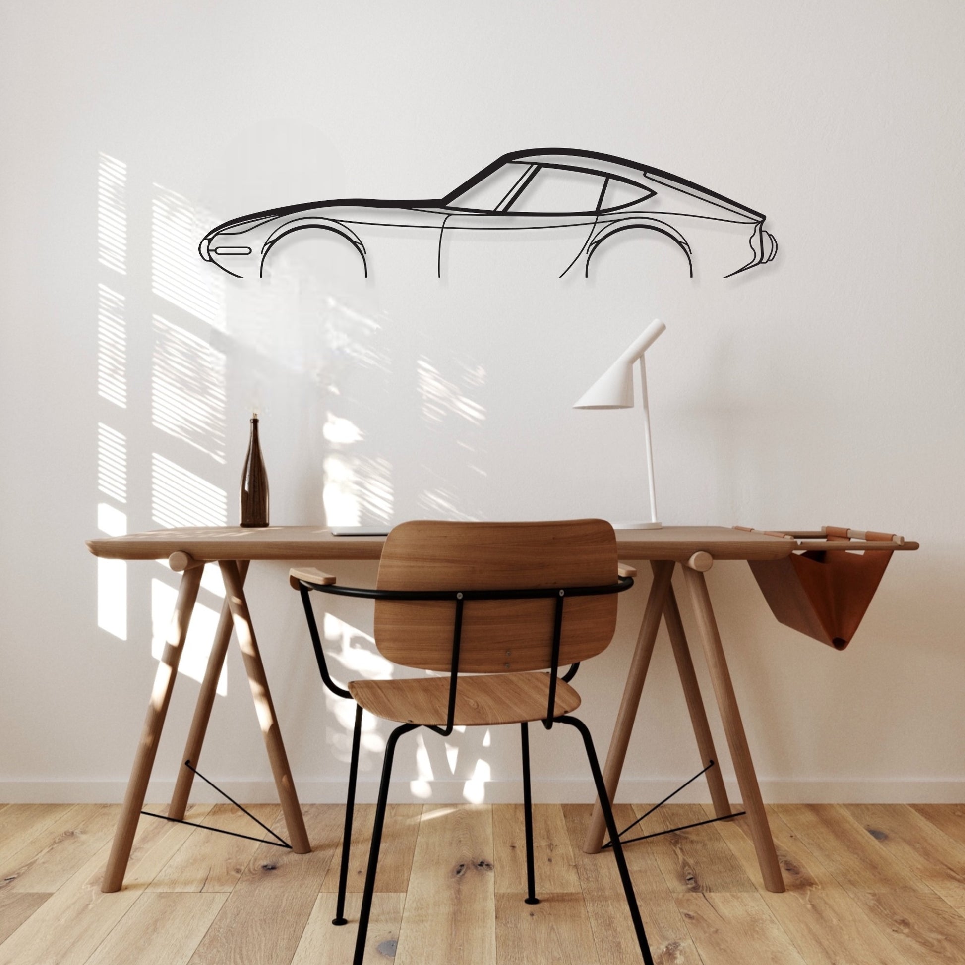 Toyota GT 2000 car silhouette wall art hangs in an office. 