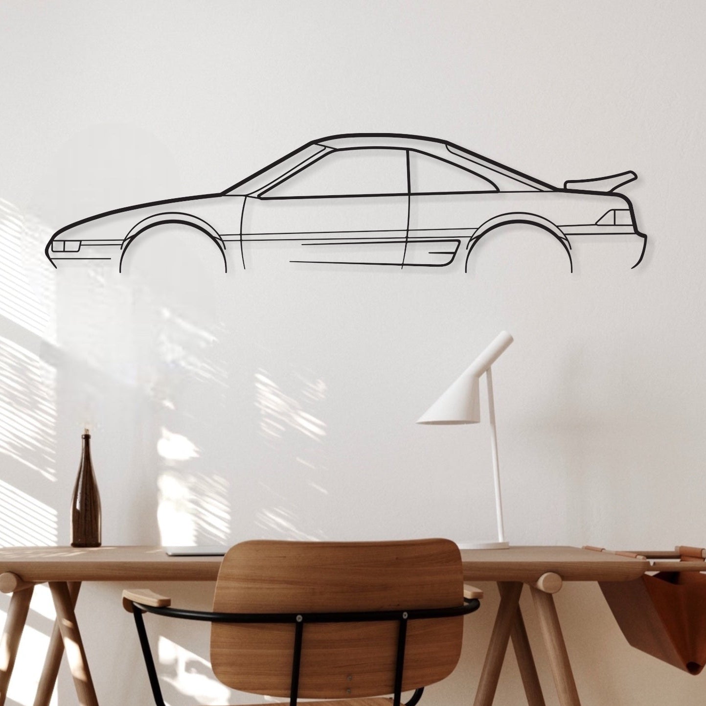 Toyota MR 2 car silhouette wall art hangs in an office. 