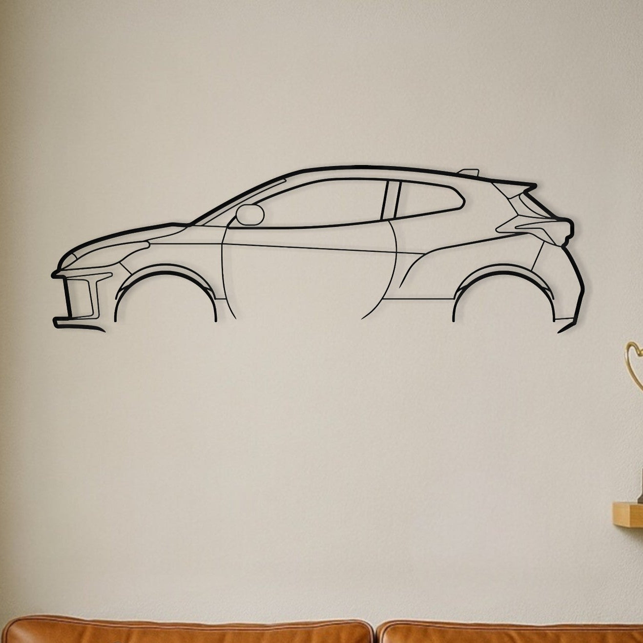Car outline wall decal on a beige wall with a brown couch in the foreground.
