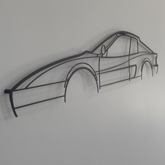 Ferrari Testerossa auto art side-on against a white wall. 