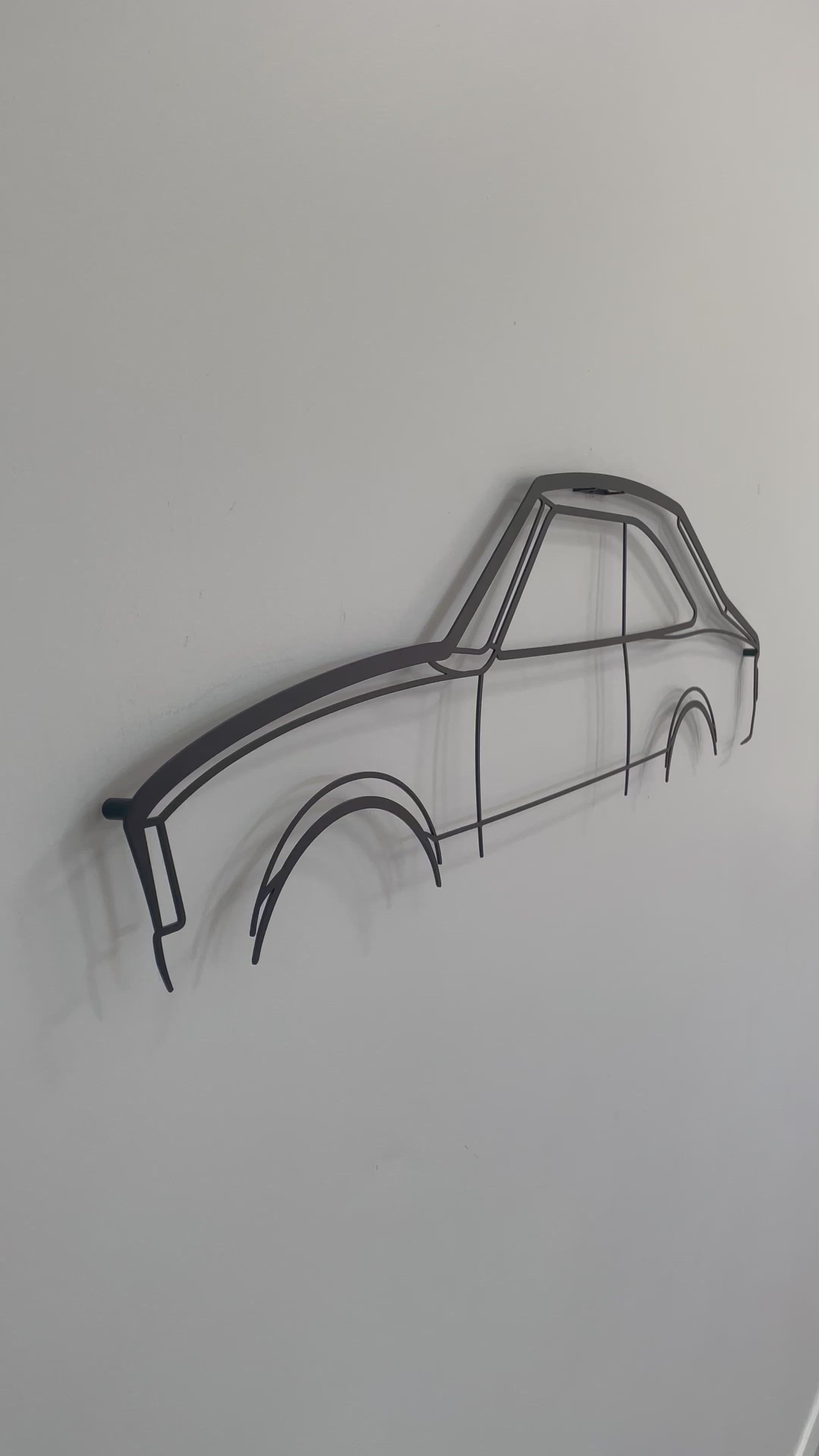 side on and close up of metal wall hanging Mazda RX2 Coupe 