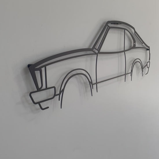 Close-up and side-on of the Mazda RX3 2 Door car metal wall art piece. 