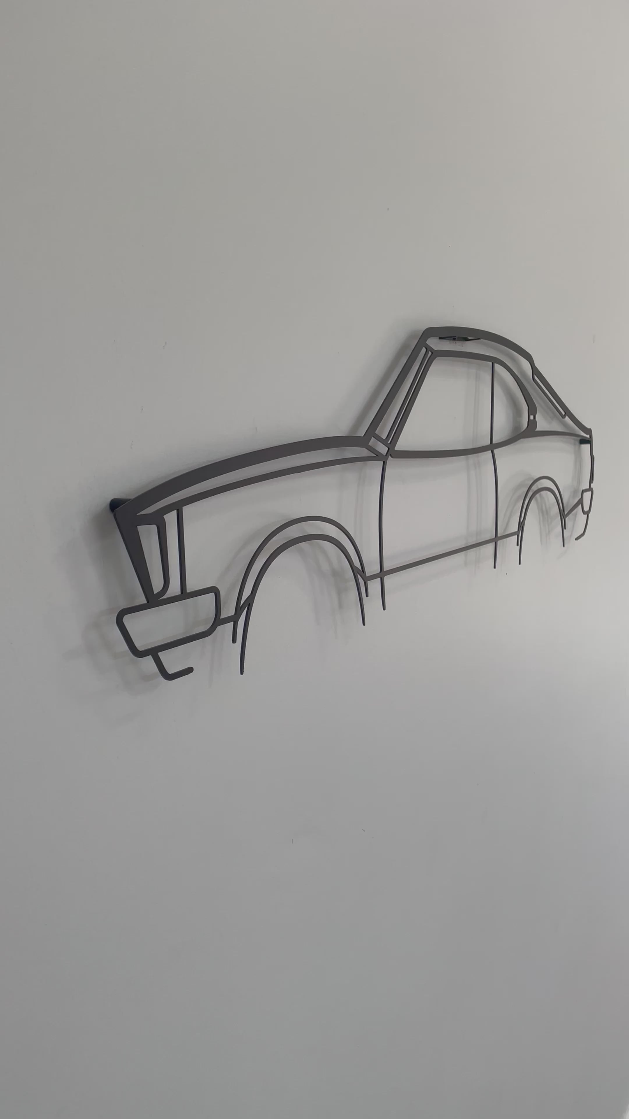 Close-up and side-on of the Mazda RX3 2 Door car metal wall art piece. 