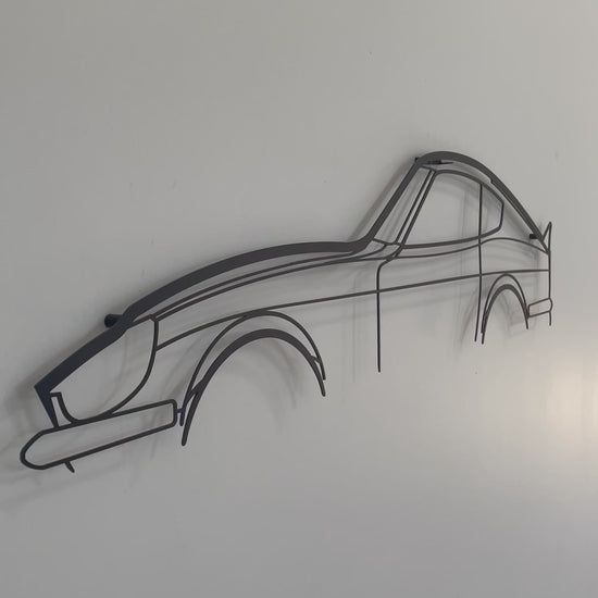 Close up and side on of the large Nissan 240z silhouette car wall hanging on a white wall